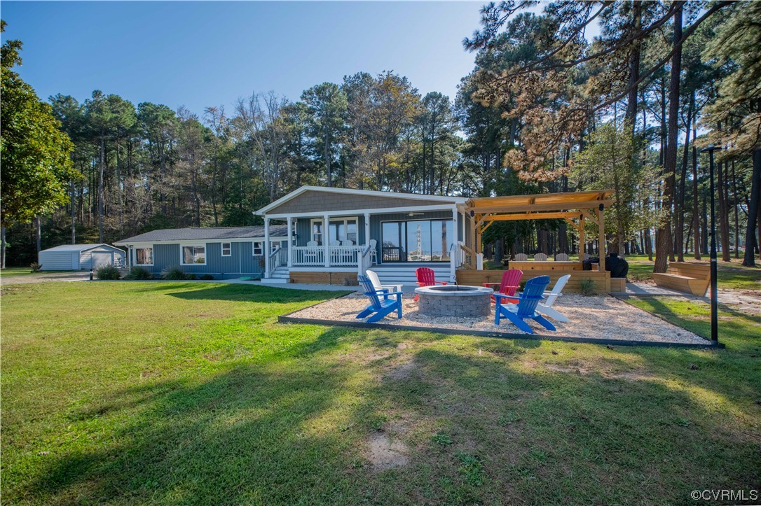 215 Riverside Drive Deltaville, VA 23043 - Photo 3 of 49 a view of a house with swimming pool and porch