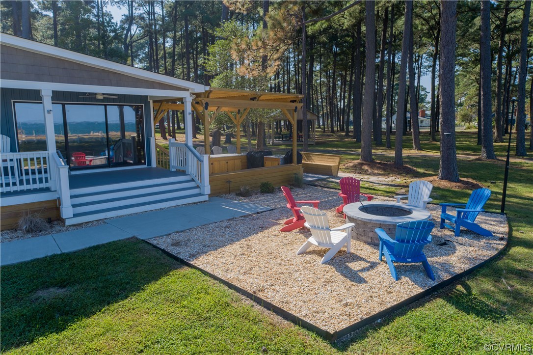 215 Riverside Drive Deltaville, VA 23043 - Photo 35 of 49 a view of a backyard with sitting area and furniture
