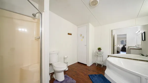 a bathroom with a granite countertop sink a toilet and shower