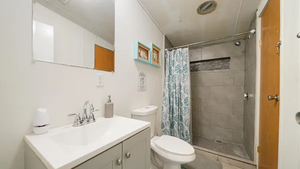 a bathroom with a sink toilet and shower