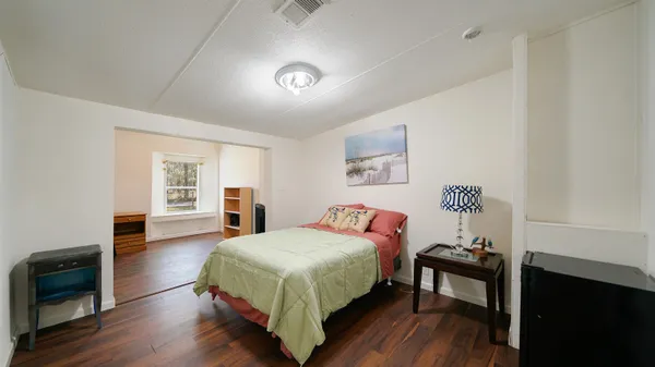 a bedroom with a bed and a table in it