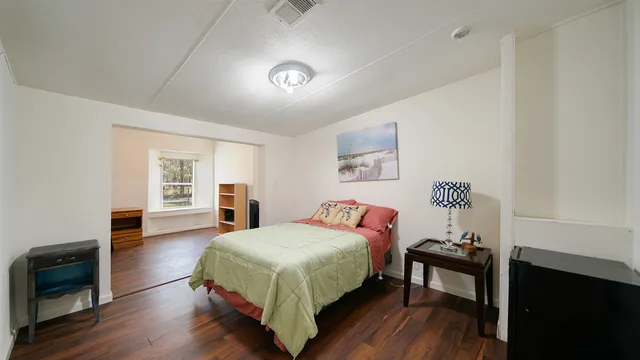 a bedroom with a bed and a table in it