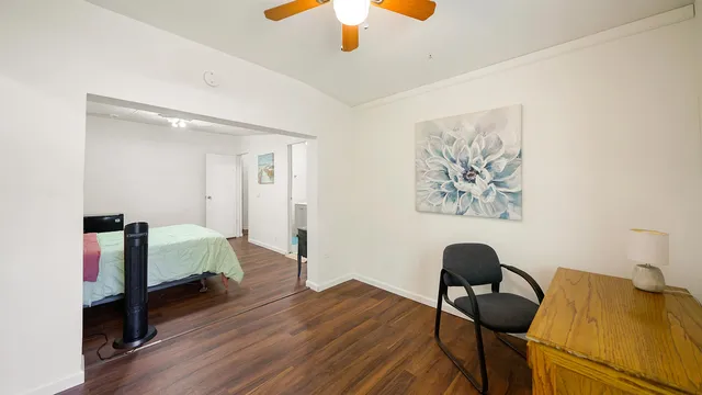 a bedroom with furniture and a wooden floor
