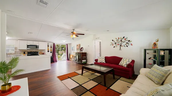 a living room with furniture and wooden floor