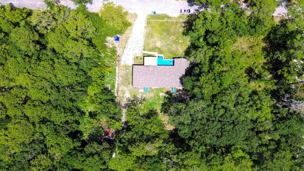 an aerial view of a house with a tree