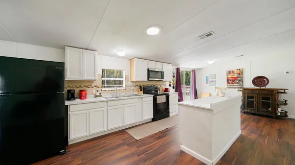 a kitchen with stainless steel appliances a refrigerator stove microwave and sink
