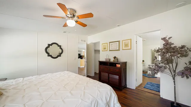 a bedroom with a bed and wooden floor