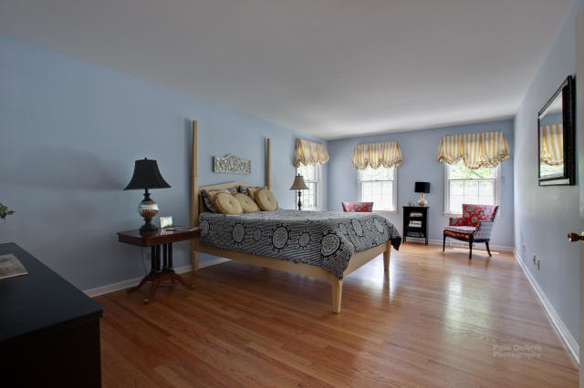 92 Old Mill Court Barrington, IL 60010 - Photo 12 of 25 a bedroom with a bed and wooden floor