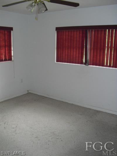 114 Texas Road Lehigh Acres, FL 33936 - Photo 8 of 8 an empty room with windows