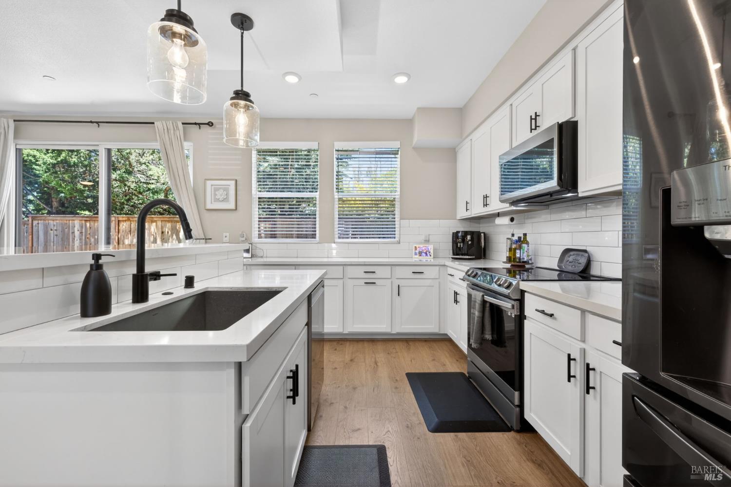 2215-2217 Versaro Drive Santa Rosa, CA 95403 - Photo 7 of 45 a kitchen with a sink stove and microwave