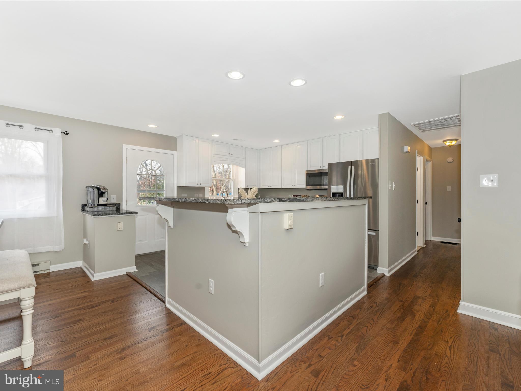4328 Dover Drive Frederick, MD 21703 - Photo 11 of 54 a kitchen with stainless steel appliances granite countertop a refrigerator a sink a stove and white cabinets with wooden floor