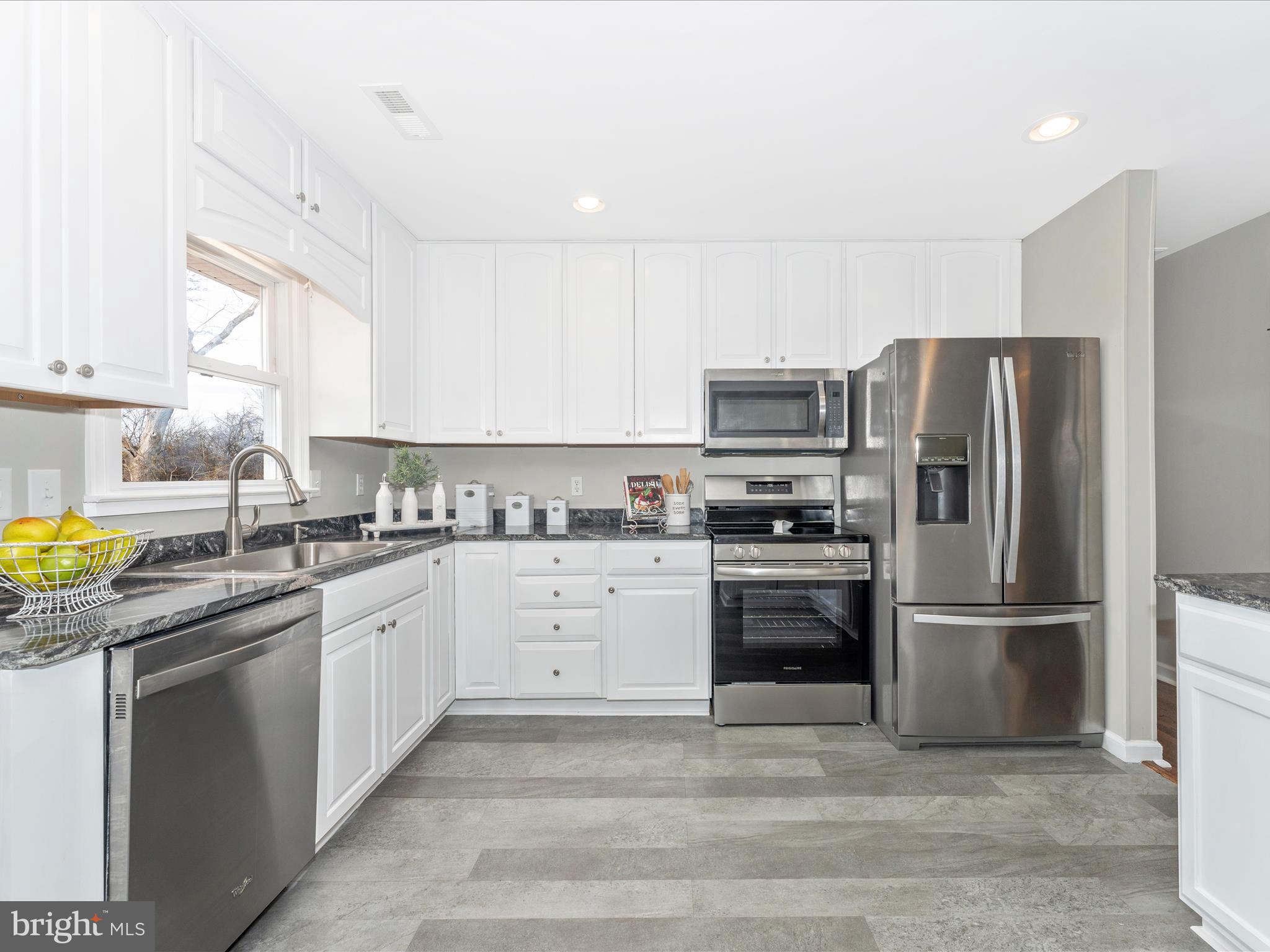 4328 Dover Drive Frederick, MD 21703 - Photo 12 of 54 a kitchen with granite countertop a refrigerator stove and sink