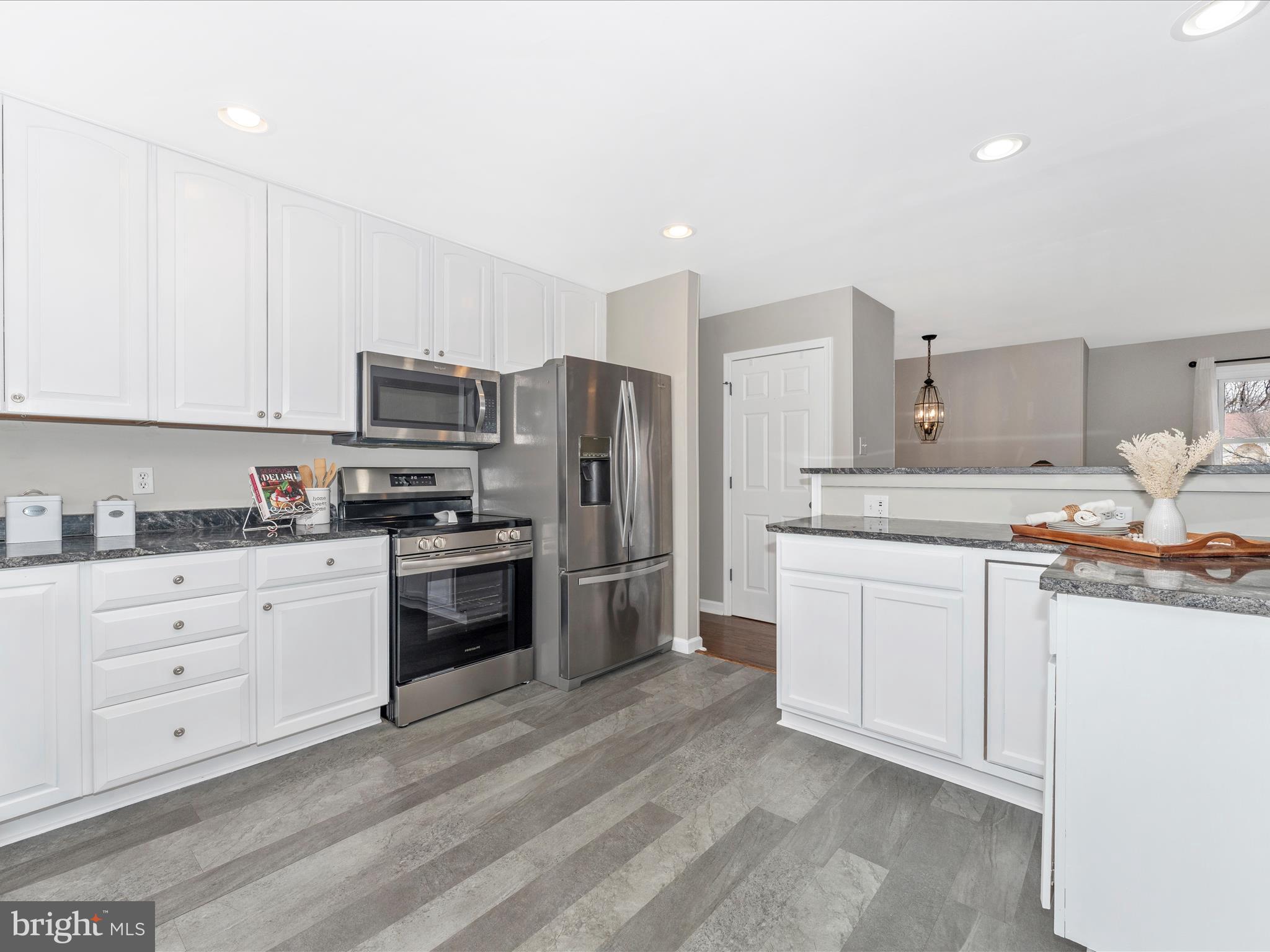 4328 Dover Drive Frederick, MD 21703 - Photo 13 of 54 a kitchen with granite countertop white cabinets and stainless steel appliances