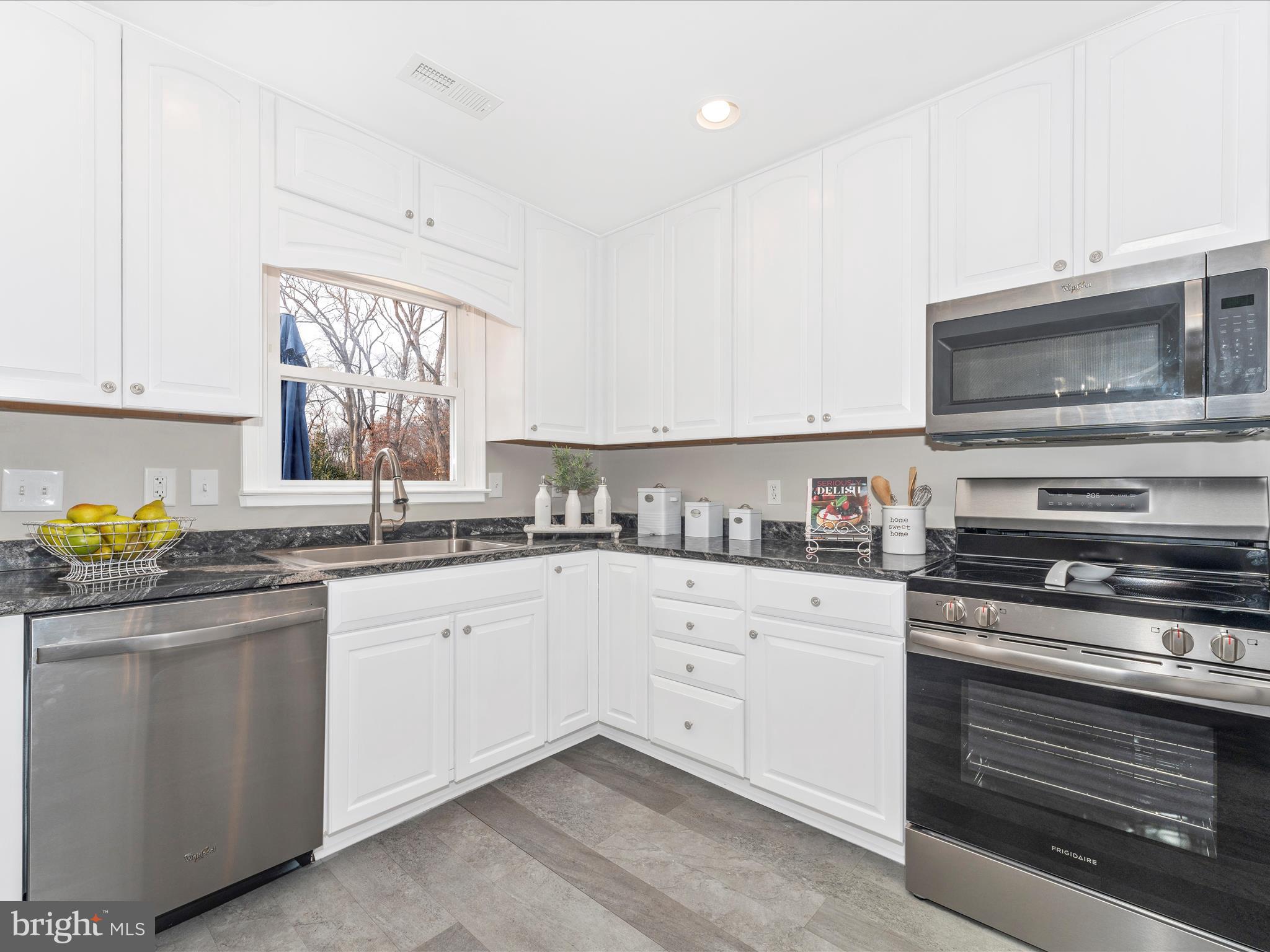 4328 Dover Drive Frederick, MD 21703 - Photo 15 of 54 a kitchen with granite countertop cabinets stainless steel appliances and a window