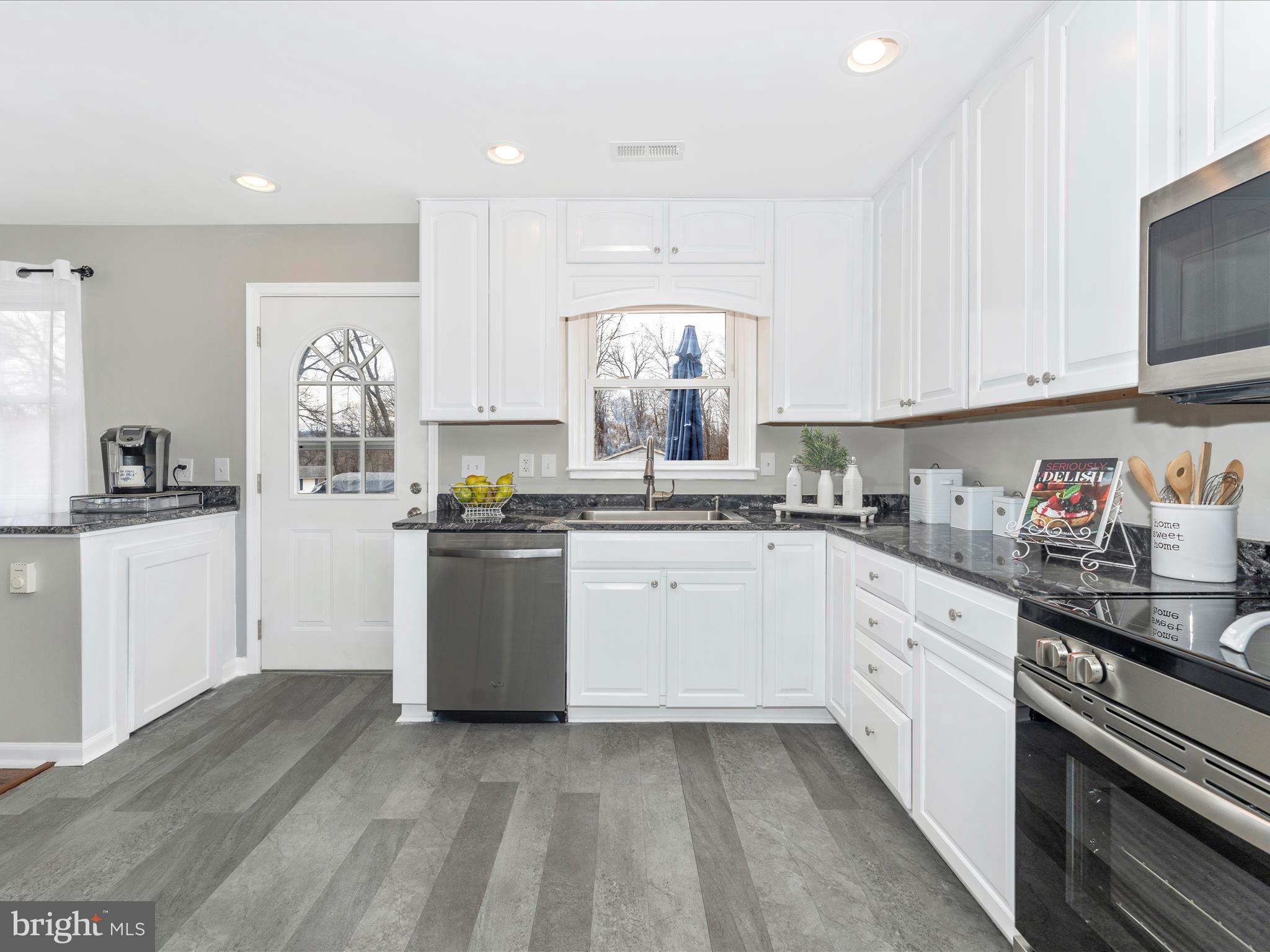4328 Dover Drive Frederick, MD 21703 - Photo 16 of 54 a kitchen with granite countertop white cabinets and white appliances