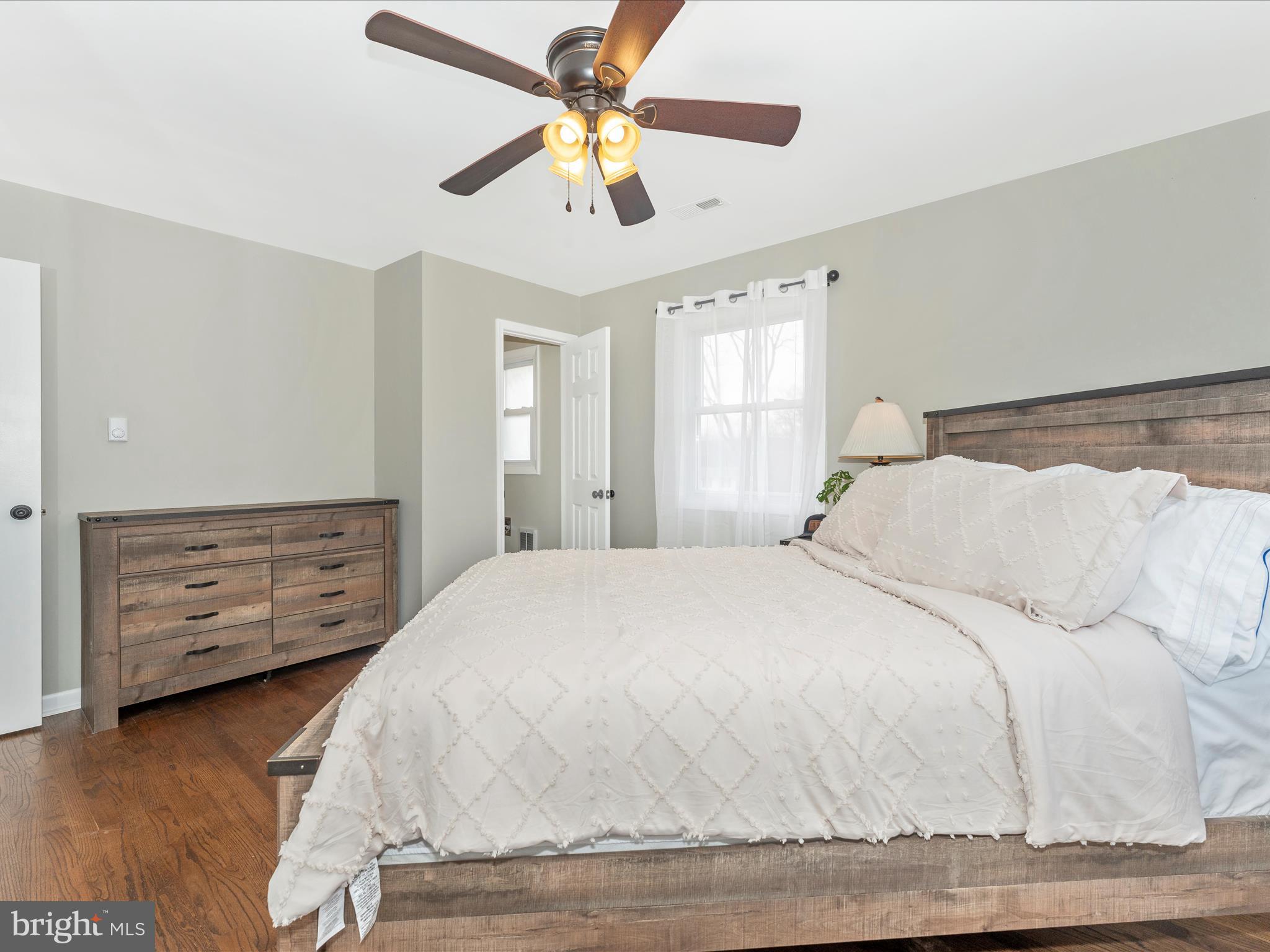 4328 Dover Drive Frederick, MD 21703 - Photo 18 of 54 a bedroom with a bed a dresser and a chandelier