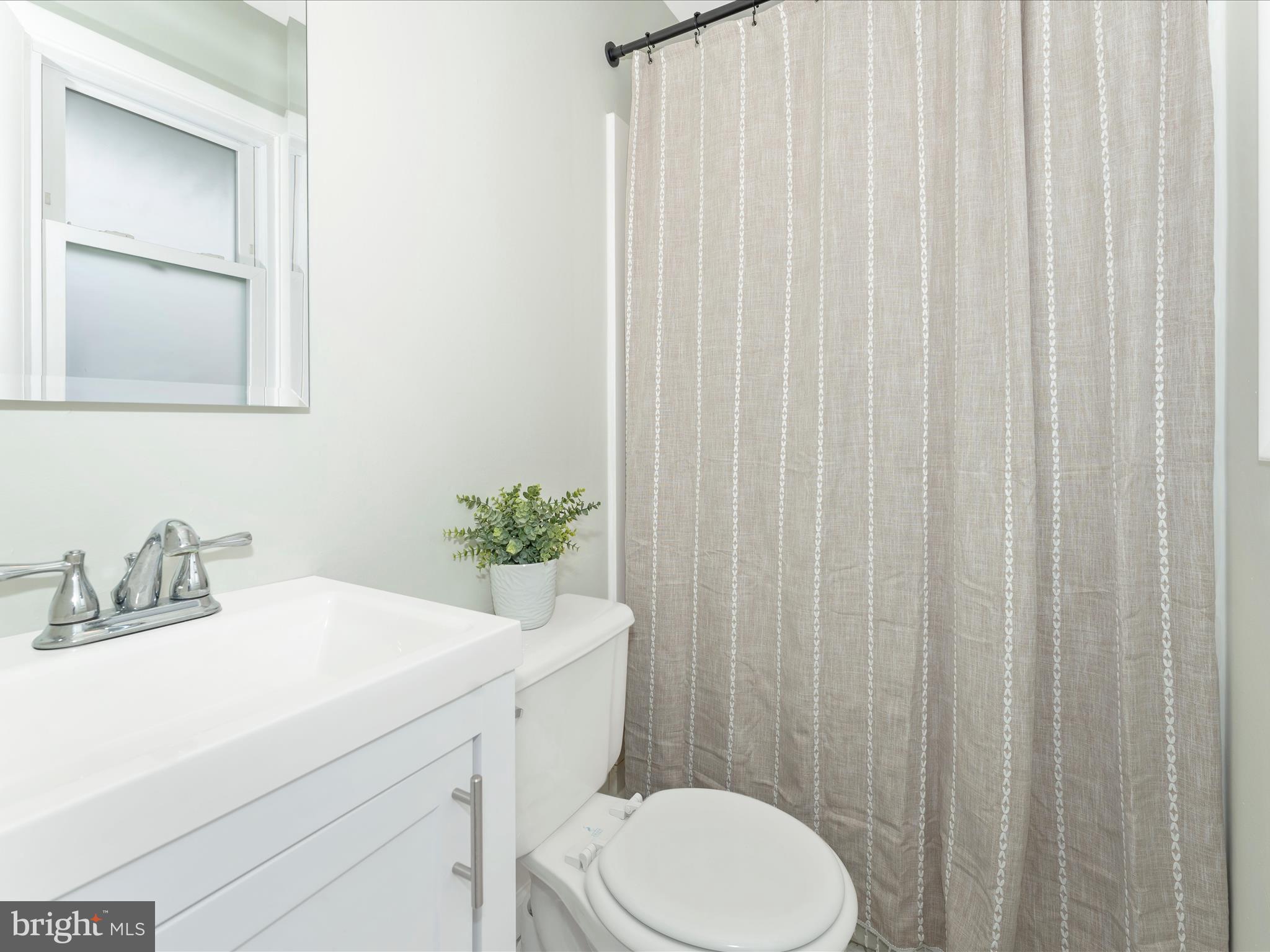 4328 Dover Drive Frederick, MD 21703 - Photo 19 of 54 a bathroom with a sink a toilet and shower curtain