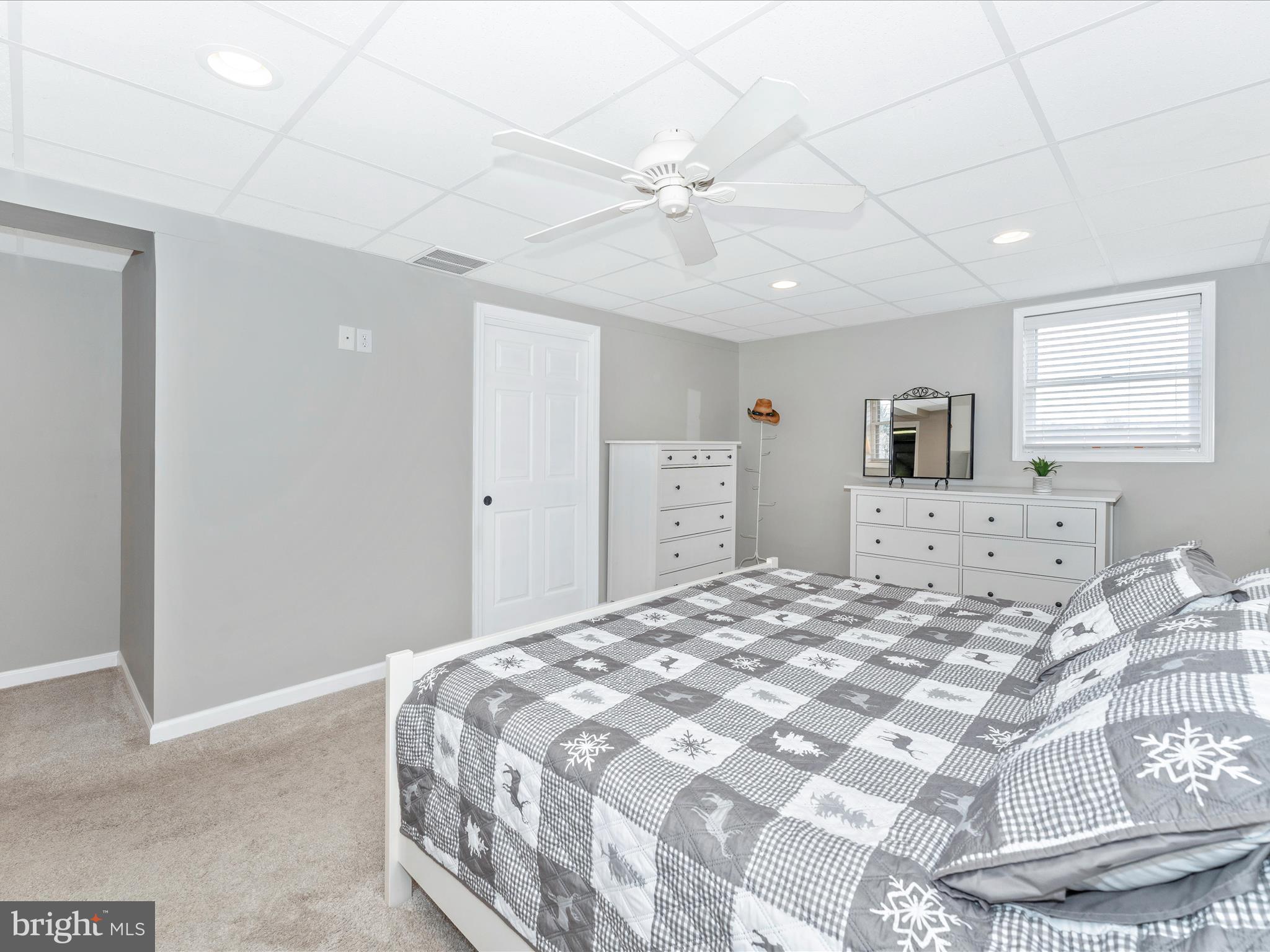 4328 Dover Drive Frederick, MD 21703 - Photo 30 of 54 a bedroom with a large bed and a chandelier