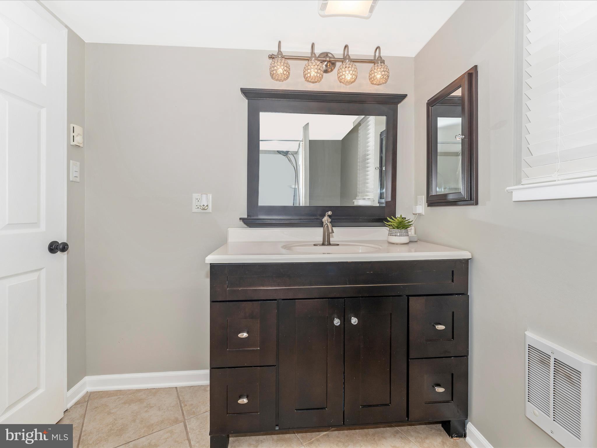 4328 Dover Drive Frederick, MD 21703 - Photo 34 of 54 a bathroom with a sink vanity and mirror