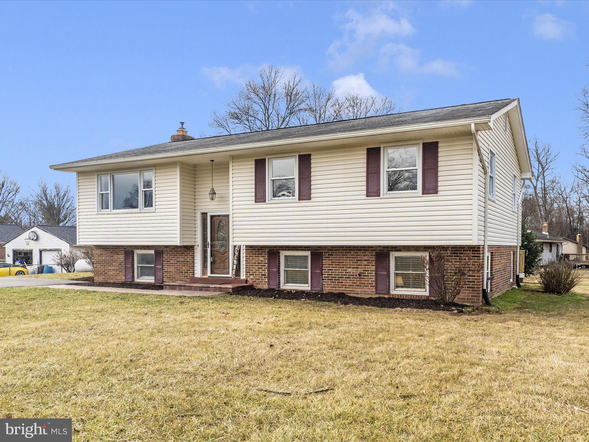 4328 Dover Drive Frederick, MD 21703 - Photo 36 of 54 a view of a white house with large windows and a yard