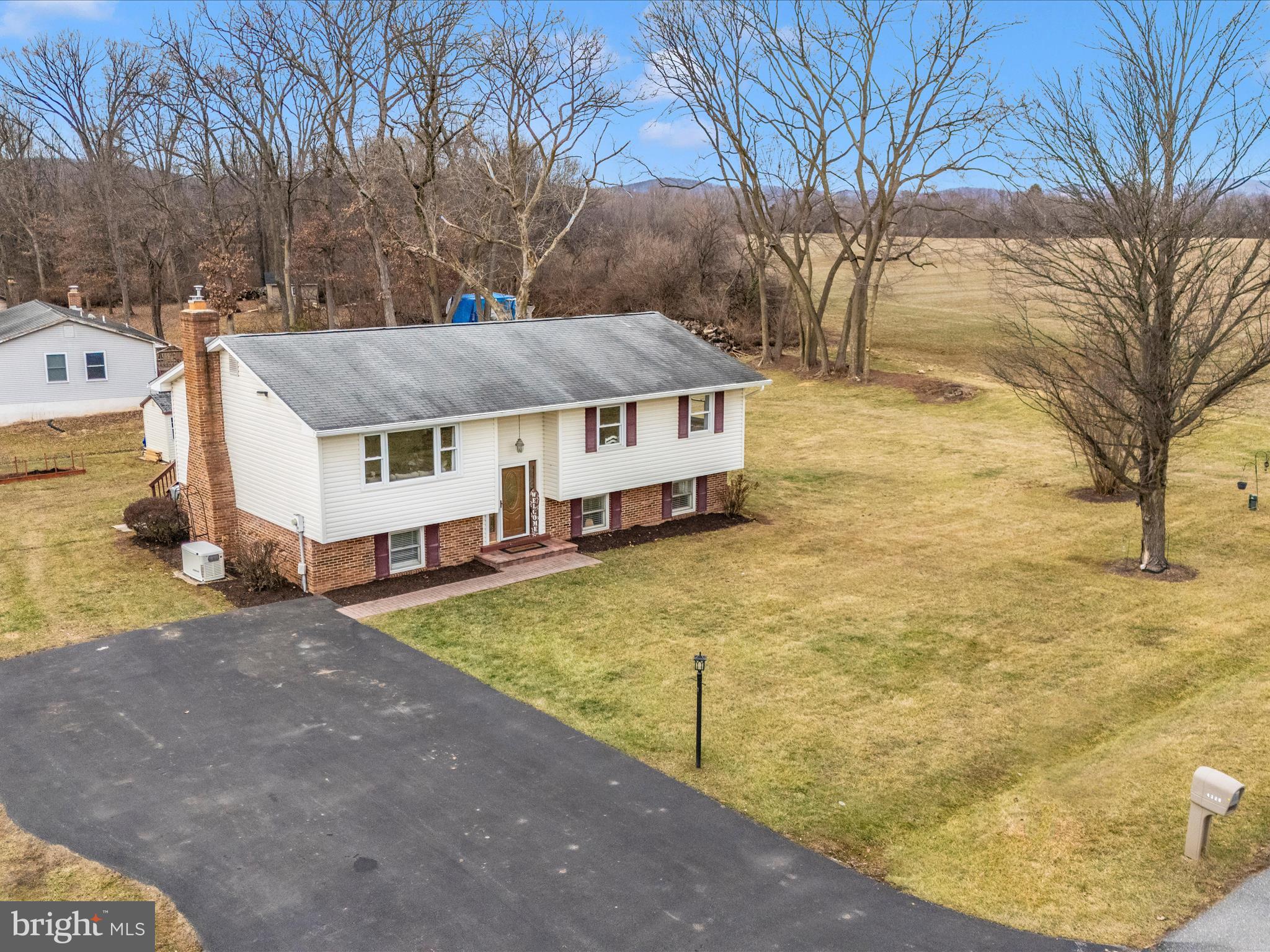 4328 Dover Drive Frederick, MD 21703 - Photo 51 of 54 a aerial view of a house with yard and trees in the background
