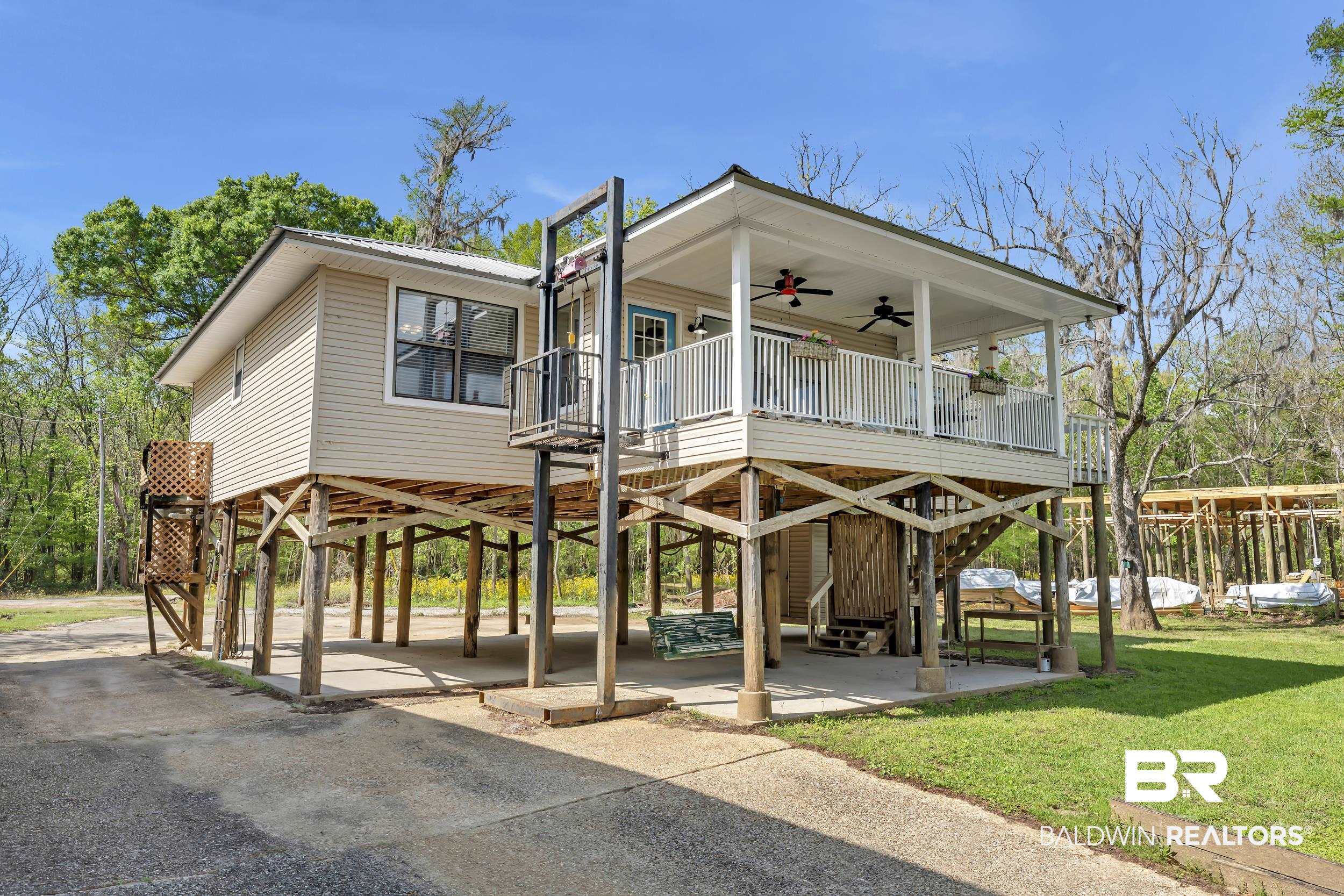 8081 Bryant's Lndg Road Stockton, AL 36579 - Photo 3 of 48 Beach home with ceiling fan, a carport, a deck, and a front lawn