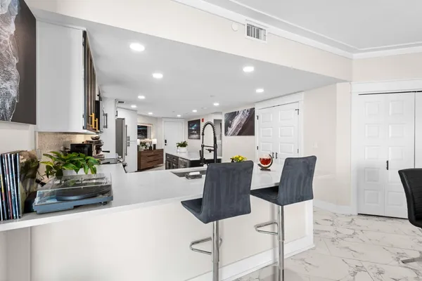 a living room with furniture a flat screen tv and a floor to ceiling window