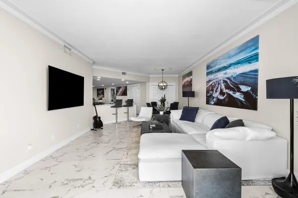 a bedroom with a bed a flat screen tv and a large window