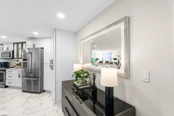 a kitchen with a refrigerator and a stove top oven
