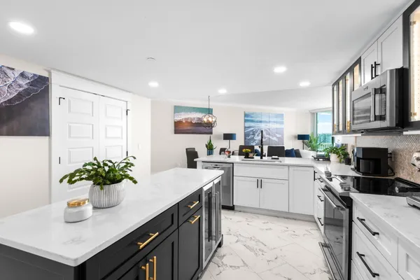 a kitchen with stainless steel appliances a refrigerator and a stove top oven