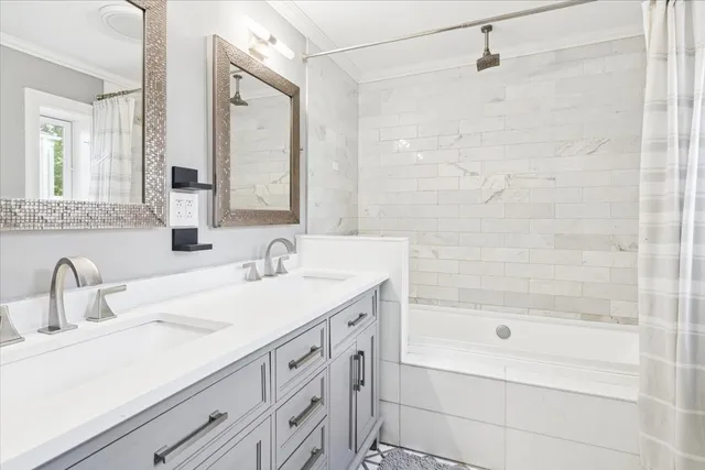 a bathroom with a tub sink and mirror