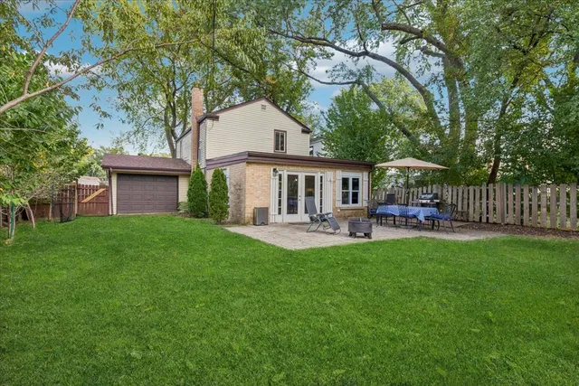 a front view of a house with yard patio and green space