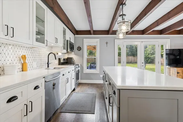 a kitchen with stainless steel appliances granite countertop a sink and cabinets