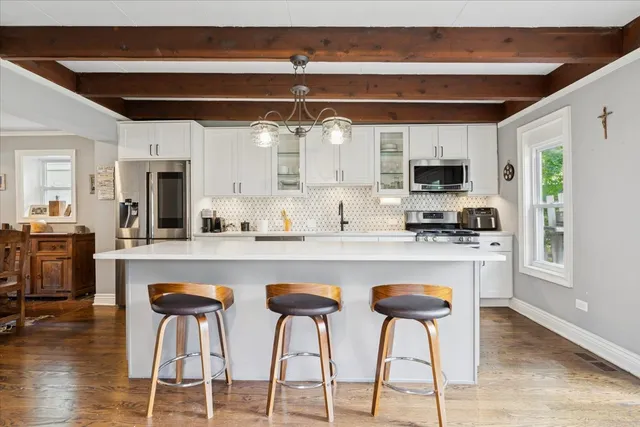 a kitchen with appliances a sink and cabinets