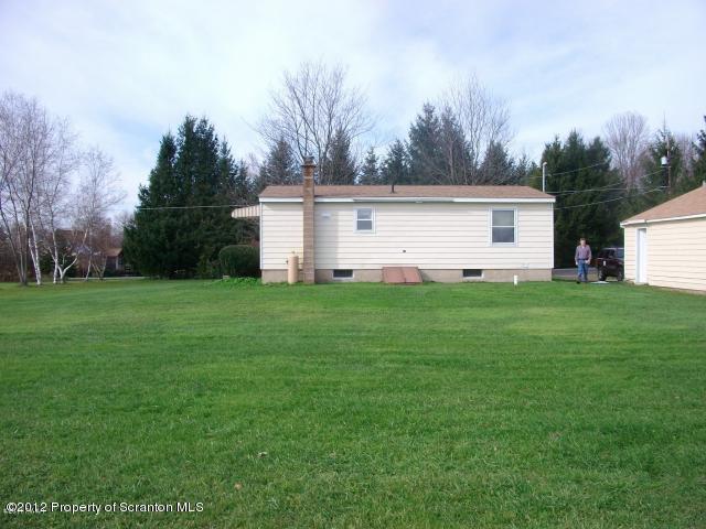 280 J & J Road Moscow, PA 18444 - Photo 2 of 7 a view of a house with a yard and a large tree