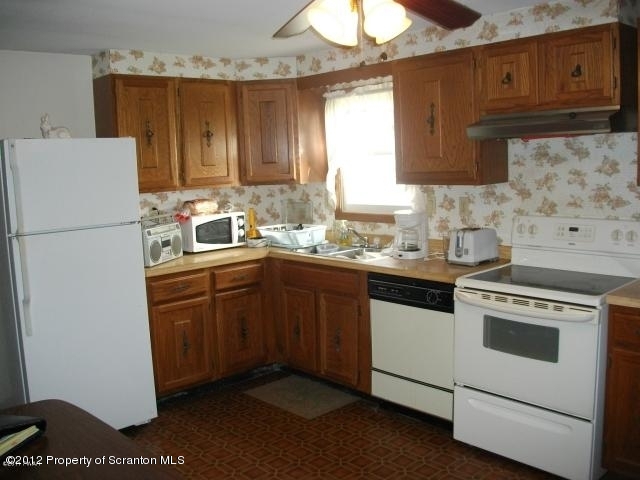 280 J & J Road Moscow, PA 18444 - Photo 3 of 7 a kitchen with a white stove top oven and refrigerator
