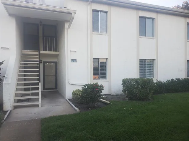 a view of a house with backyard and a garden