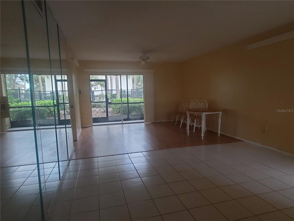 107 Cypress Court, Unit 2C Oldsmar, FL 34677 - Photo 5 of 12 a view of an empty room with glass door