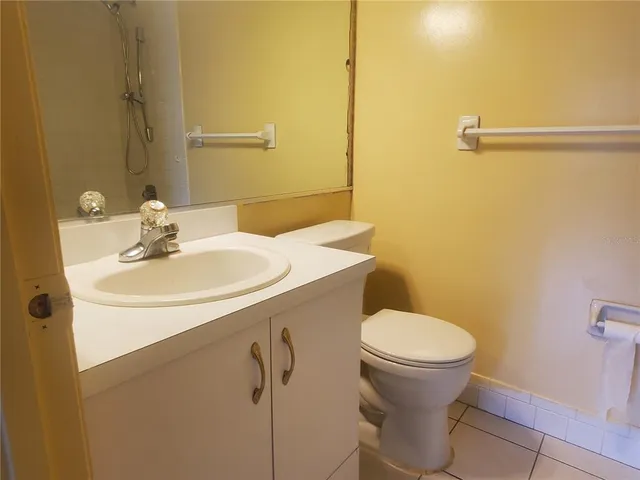 a bathroom with a sink toilet and a mirror