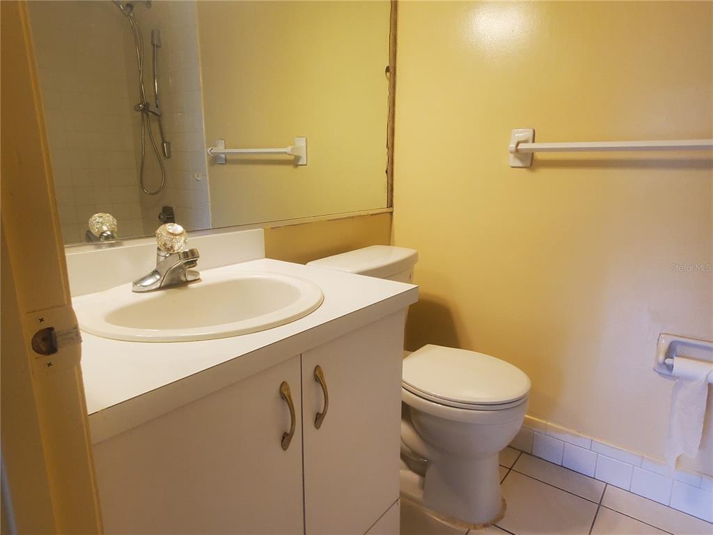 107 Cypress Court, Unit 2C Oldsmar, FL 34677 - Photo 7 of 12 a bathroom with a sink toilet and a mirror