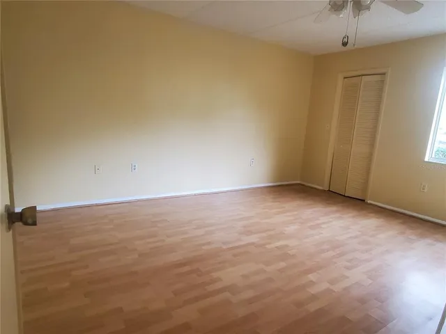 an empty room with a empty space and windows