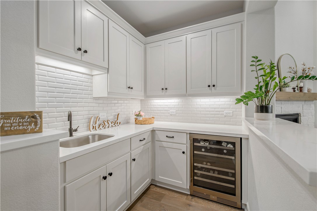4309 Batona Court Bryan, TX 77802 - Photo 12 of 27 a kitchen with stainless steel appliances white cabinets and a sink