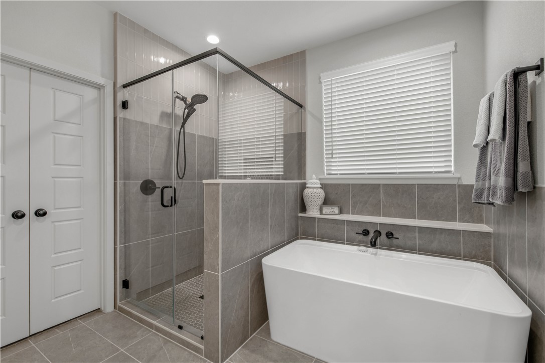 4309 Batona Court Bryan, TX 77802 - Photo 17 of 27 a bathroom with a bathtub and shower