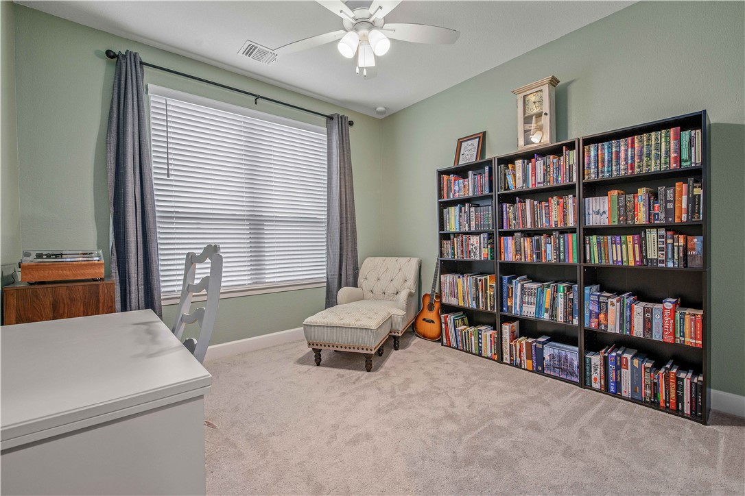 4309 Batona Court Bryan, TX 77802 - Photo 22 of 27 a living room with furniture and book shelf