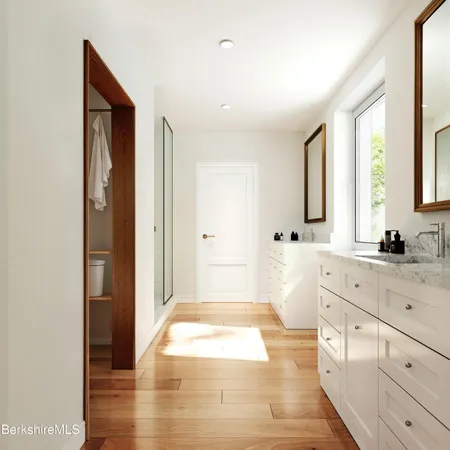 a spacious bathroom with a granite countertop sink a mirror and a bathtub