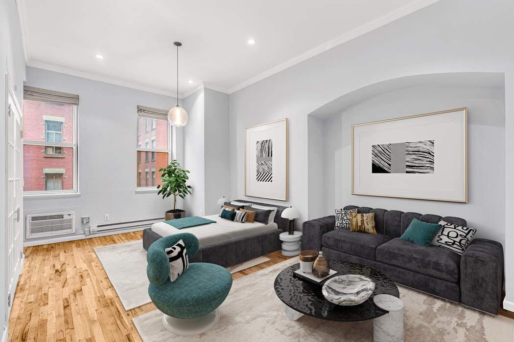 23 Waverly Place, Unit 3B Manhattan, NY 10003 - Photo 3 of 7 a living room with furniture a rug and a chandelier