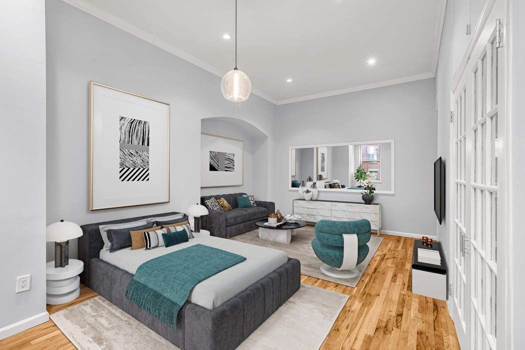 23 Waverly Place, Unit 3B Manhattan, NY 10003 - Photo 4 of 7 a living room with furniture and a large window