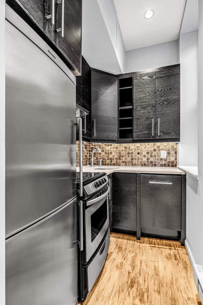 23 Waverly Place, Unit 3B Manhattan, NY 10003 - Photo 5 of 7 a bathroom with a sink and a mirror