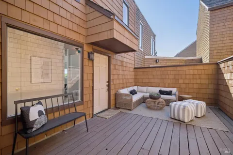 a view of a patio with wooden floor