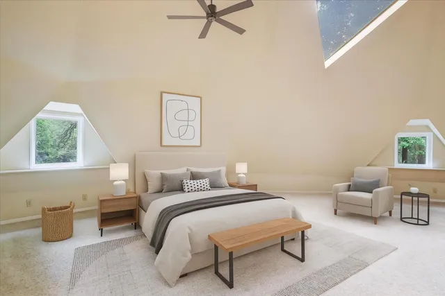 an aerial view of a house with a yard and covered with trees